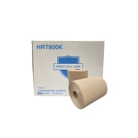 Rolls of kraft hardwound towels in front of their box.